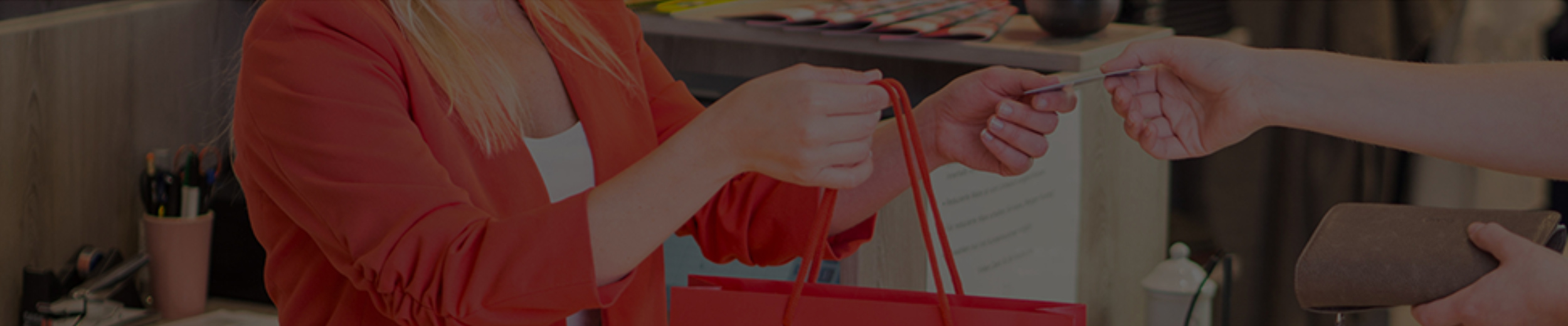 Woman In Red Shirt Holding A Red Shopping Bag