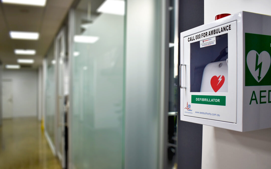 AED Authority Lifepak CR2 Essential with cabinet in a workplace